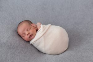 newborn-baby-wrapped-with-soft-pink-tissue