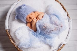 pretty-little-child-sleeps-fluffy-pillow-blue-background